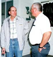 Paul Hasko (left) visits the home of a Gulf War veteran to discuss the health problems each is suffering. (outskirts of Jonesborough, Tennessee)