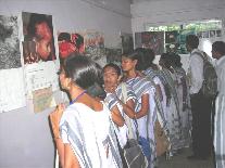 Visitors look carefully at photo panels of the atomic bombings.