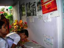 Visitors write their impressions of the museum in a notebook.